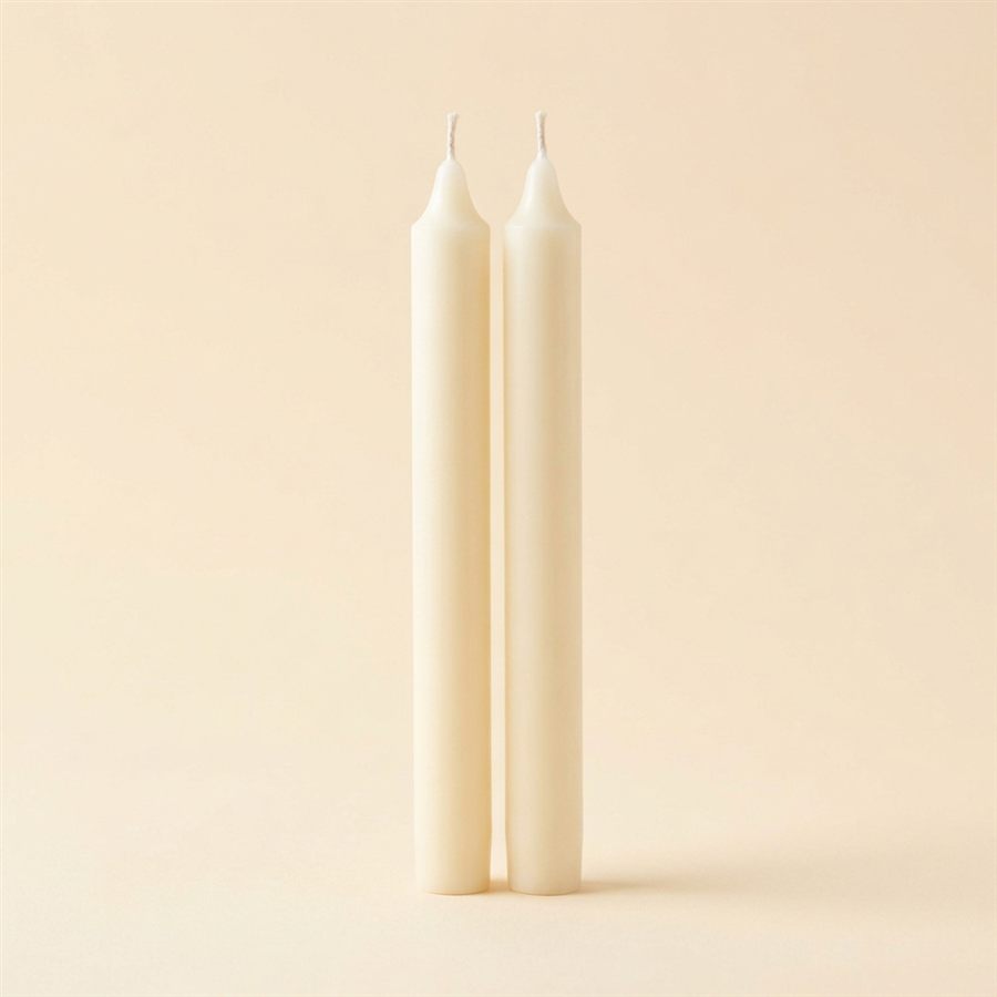 A pair of tall cream taper candles